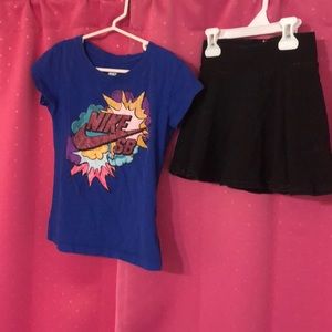Girls Nike tee with black justice skort.